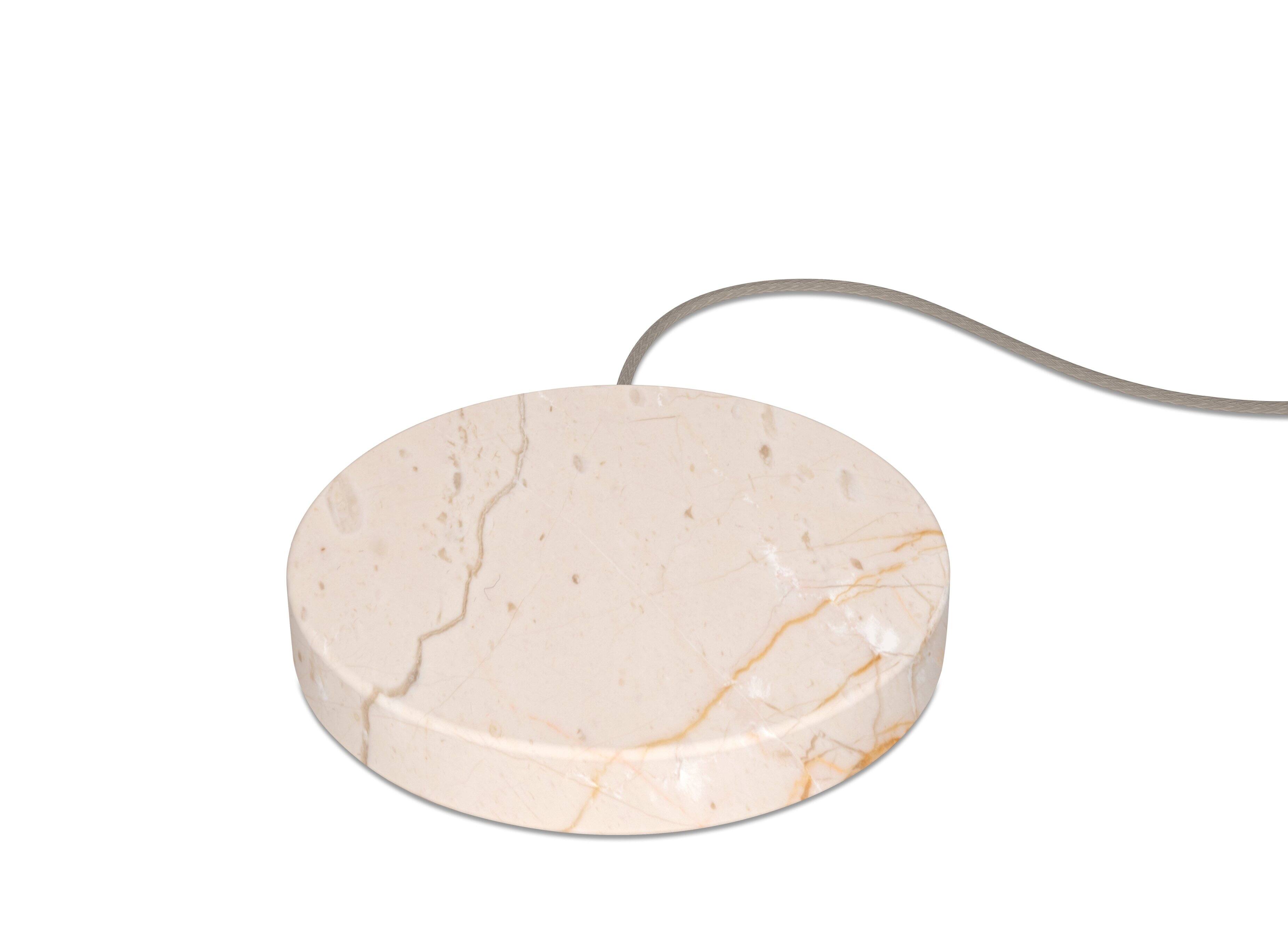 Einova Charging Stone placed on a desk with a smartphone charging