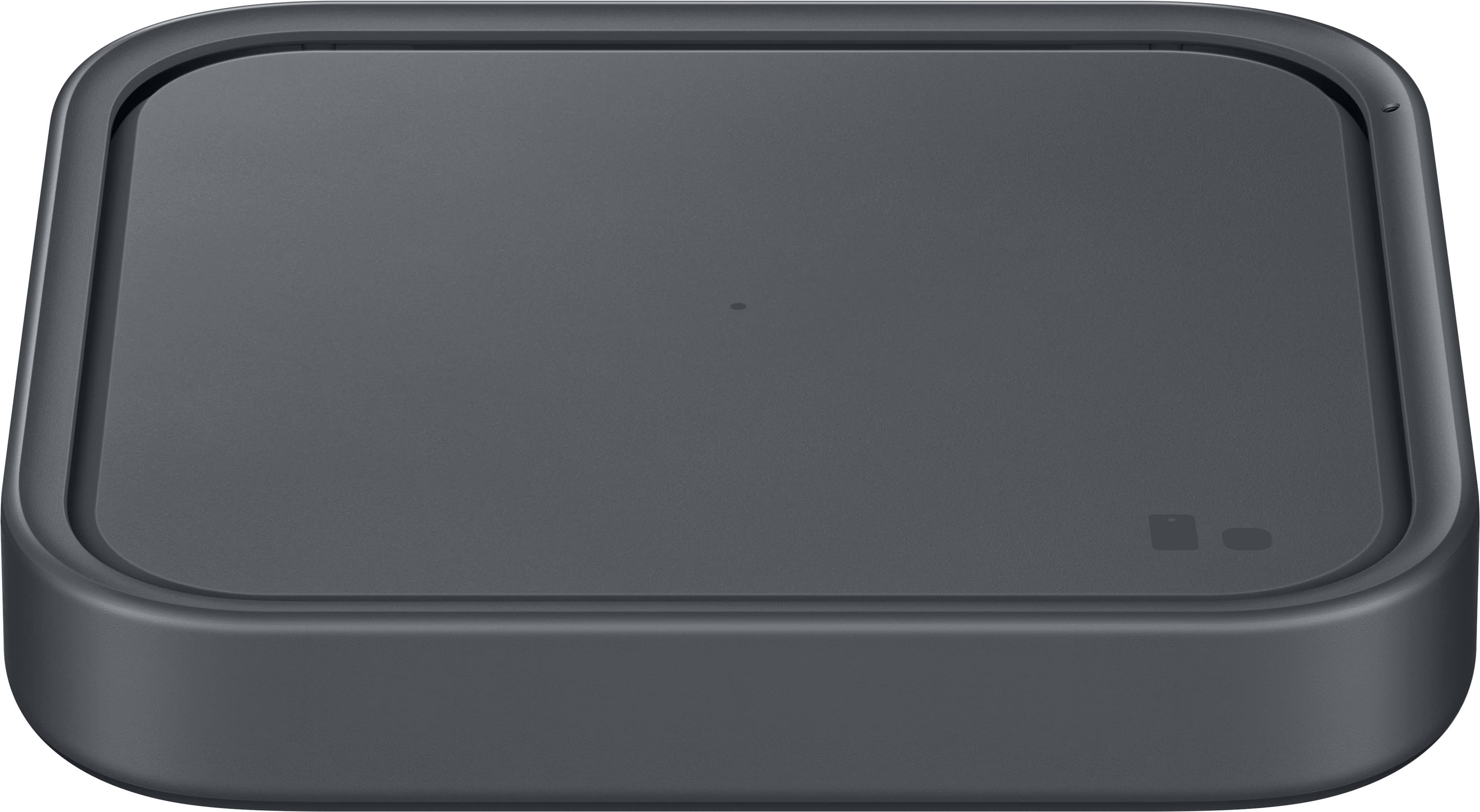 Samsung Wireless Charger Pad placed on a desk with a smartphone charging